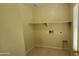 Functional laundry room ready for appliance hookups, featuring tile flooring at 5628 S 21St Pl, Phoenix, AZ 85040