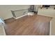 Spacious living room featuring wood floors and a stylish spiral staircase at 5628 S 21St Pl, Phoenix, AZ 85040