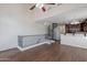 Bright open living area featuring high ceilings, hardwood floors, spiral staircase, and a kitchen view at 5628 S 21St Pl, Phoenix, AZ 85040