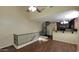 Open-concept living room featuring wood floors, spiral staircase, and kitchen bar at 5628 S 21St Pl, Phoenix, AZ 85040