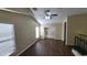 Upstairs loft with high ceilings, ceiling fan, two bright windows, and staircase views at 5628 S 21St Pl, Phoenix, AZ 85040