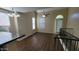 Loft area with wood flooring, a ceiling fan, and an adjacent kitchen with granite countertops at 5628 S 21St Pl, Phoenix, AZ 85040