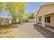Spacious backyard featuring mature trees, a desert landscape and a covered patio at 5926 W Questa Dr, Glendale, AZ 85310