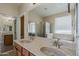 Bathroom featuring a double sink vanity, large mirror, and walk-in shower and tub at 5926 W Questa Dr, Glendale, AZ 85310