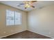 Cozy bedroom with hardwood floors, a ceiling fan, and a window with horizontal blinds at 5926 W Questa Dr, Glendale, AZ 85310