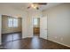 Bedroom featuring ceiling fan, wood floors, and a mirrored closet, offering ample storage at 5926 W Questa Dr, Glendale, AZ 85310
