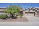 Charming single-story home with a well-manicured front yard and two-car garage at 5926 W Questa Dr, Glendale, AZ 85310