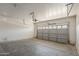 Spacious two-car garage with gray door, concrete floor and ample storage at 5926 W Questa Dr, Glendale, AZ 85310