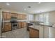 Modern kitchen with stainless steel appliances, granite countertops, and ample cabinet space at 5926 W Questa Dr, Glendale, AZ 85310