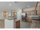 Open kitchen features stainless steel appliances and granite countertops, ideal for meal preparation at 5926 W Questa Dr, Glendale, AZ 85310