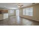 Open living room area with tile floors, large windows, and a view of the kitchen at 5926 W Questa Dr, Glendale, AZ 85310