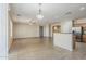 Open floor plan featuring tile flooring, kitchen island, and views into other rooms at 5926 W Questa Dr, Glendale, AZ 85310