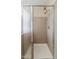 Shower showcasing neutral tile with a glass door and dual shower heads at 5926 W Questa Dr, Glendale, AZ 85310