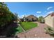 Spacious backyard featuring artificial turf, a covered patio, and mature landscaping, ideal for outdoor entertaining and relaxation at 6135 E Aire Libre Ln, Scottsdale, AZ 85254