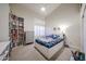 Cozy bedroom features a bed, shuttered window and bookcase at 6135 E Aire Libre Ln, Scottsdale, AZ 85254