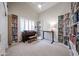 Bright bedroom/office features a piano, desk, vaulted ceilings and multiple bookshelves at 6135 E Aire Libre Ln, Scottsdale, AZ 85254