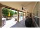 Enjoy outdoor living on this covered patio with ceiling fans, overlooking a pool and an outdoor kitchen area at 6135 E Aire Libre Ln, Scottsdale, AZ 85254