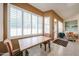 Bright dining area with plantation shutters, tile flooring, and access to the backyard at 6135 E Aire Libre Ln, Scottsdale, AZ 85254