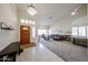 Bright foyer leading into a spacious living room with vaulted ceilings, large windows and tile-carpet flooring at 6135 E Aire Libre Ln, Scottsdale, AZ 85254