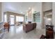 Bright living room featuring tile floors, a fireplace, built-in shelving, and access to the backyard at 6135 E Aire Libre Ln, Scottsdale, AZ 85254