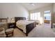 Bright main bedroom featuring neutral tones, a large window, and an ensuite bathroom for a peaceful retreat at 6135 E Aire Libre Ln, Scottsdale, AZ 85254