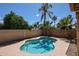 Sparkling pool surrounded by lush landscaping, creating a serene and private backyard oasis perfect for relaxing at 6135 E Aire Libre Ln, Scottsdale, AZ 85254
