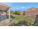 Backyard featuring a covered patio, grass, and trees at 648 W Cobblestone Dr, Casa Grande, AZ 85122
