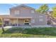 View of the backyard, patio, grass, and the back of the two-story home at 648 W Cobblestone Dr, Casa Grande, AZ 85122