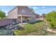 Fenced backyard with grass, covered patio, and the back of the home at 648 W Cobblestone Dr, Casa Grande, AZ 85122