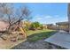 Spacious backyard featuring a swing set, grass, and privacy fence at 648 W Cobblestone Dr, Casa Grande, AZ 85122