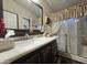 Bathroom featuring a dark vanity, large mirror and a glass shower at 650 N Hawes Rd # 4123, Mesa, AZ 85207