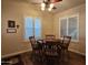 A charming dining area features a wooden table, four chairs and plantation shutters for a light-filled room at 650 N Hawes Rd # 4123, Mesa, AZ 85207