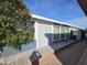 Side of a cozy one-story house with a well-maintained side yard and mature foliage at 650 N Hawes Rd # 4123, Mesa, AZ 85207