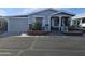 Charming single-story home with a well-maintained yard and inviting front porch at 650 N Hawes Rd # 4123, Mesa, AZ 85207