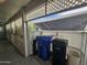 Exterior view of a covered patio space with trash and recycle bins, providing functional outdoor storage at 650 N Hawes Rd # 4123, Mesa, AZ 85207