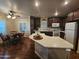 Open kitchen featuring dark wood cabinets, a large center island, and a breakfast nook with natural light at 650 N Hawes Rd # 4123, Mesa, AZ 85207