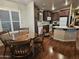 Kitchen and dining area showcasing dark wood cabinets, white appliances, and hardwood flooring at 650 N Hawes Rd # 4123, Mesa, AZ 85207