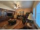 Charming living room with dark wood built-ins, fireplace, wood floors, and comfortable seating at 650 N Hawes Rd # 4123, Mesa, AZ 85207