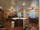 Open concept living room features wood flooring, neutral paint, plantation shutters, and a kitchen island at 650 N Hawes Rd # 4123, Mesa, AZ 85207