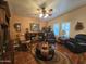 Comfortable living room featuring hardwood floors, ceiling fan, and fireplace at 650 N Hawes Rd # 4123, Mesa, AZ 85207