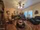 A cozy living room with a fireplace, dark wood accents, seating and a decorative center table at 650 N Hawes Rd # 4123, Mesa, AZ 85207