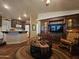 Spacious living room with wood floors, opens to the kitchen and features custom built-in shelving at 650 N Hawes Rd # 4123, Mesa, AZ 85207
