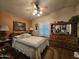 Cozy bedroom with a ceiling fan, dresser, and natural light at 650 N Hawes Rd # 4123, Mesa, AZ 85207