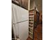 A refrigerator with an adjacent, open pantry reveals convenient shelving with canned goods for maximum storage at 650 N Hawes Rd # 4123, Mesa, AZ 85207