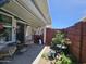 Enclosed patio area featuring seating, an artificial fireplace, and garden area with plants and bird bath at 650 N Hawes Rd # 4123, Mesa, AZ 85207