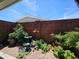 Enclosed patio showcasing a tranquil garden area with brick wall, plants, bird bath and rocks at 650 N Hawes Rd # 4123, Mesa, AZ 85207