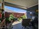 Covered patio showing a tranquil garden area with bird bath, seating, decor, and brick wall at 650 N Hawes Rd # 4123, Mesa, AZ 85207