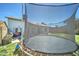 Trampoline in the backyard with lush green grass at 6826 S 16Th Way, Phoenix, AZ 85042