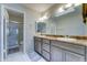 Bathroom with double sinks, and a walk-in shower with glass doors at 6826 S 16Th Way, Phoenix, AZ 85042
