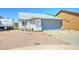 Charming single-story home with a gray and white exterior, a two-car garage, and a well-kept yard at 6826 S 16Th Way, Phoenix, AZ 85042